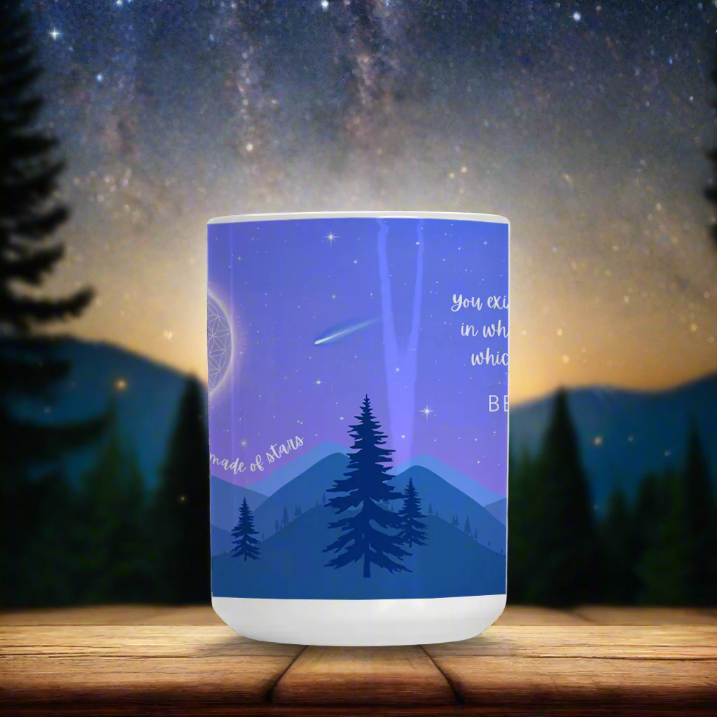 Ceramic mug featuring a starry night sky over mountains, with the Flower of Life as the moon, a commemorative comet, and the phrase 'You are made of stars - BE THE LIGHT' inspiring mindfulness and cosmic connection.